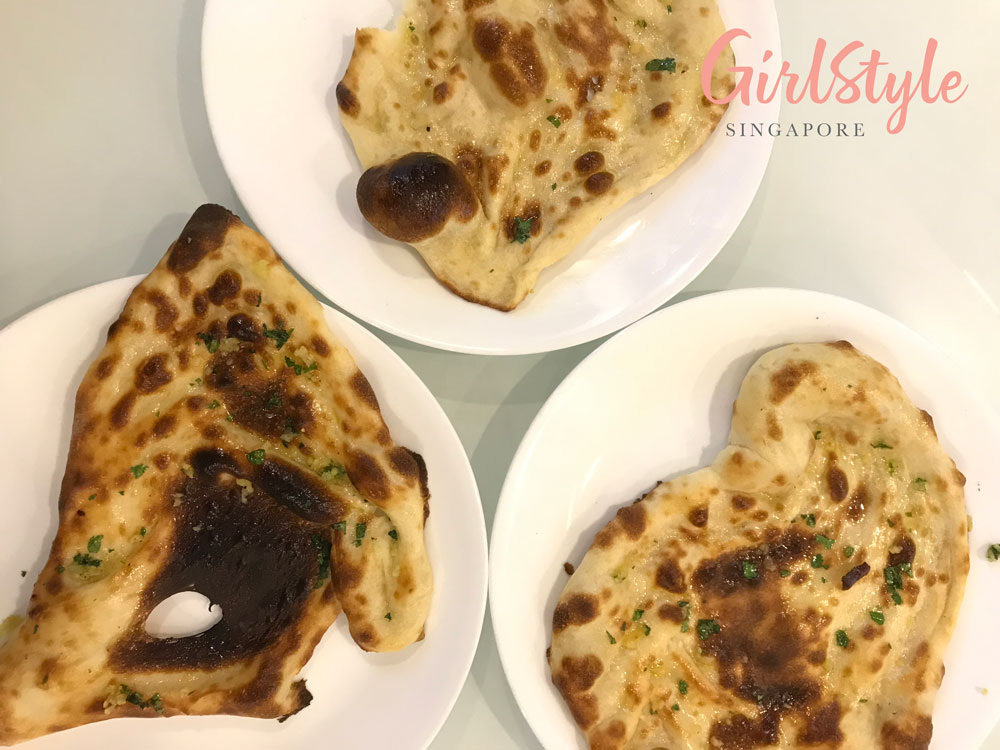 three pieces of butter and garlic naan