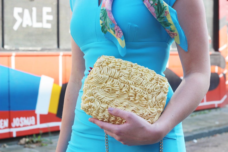 woman carrying instant Noodles Purse as a clutch