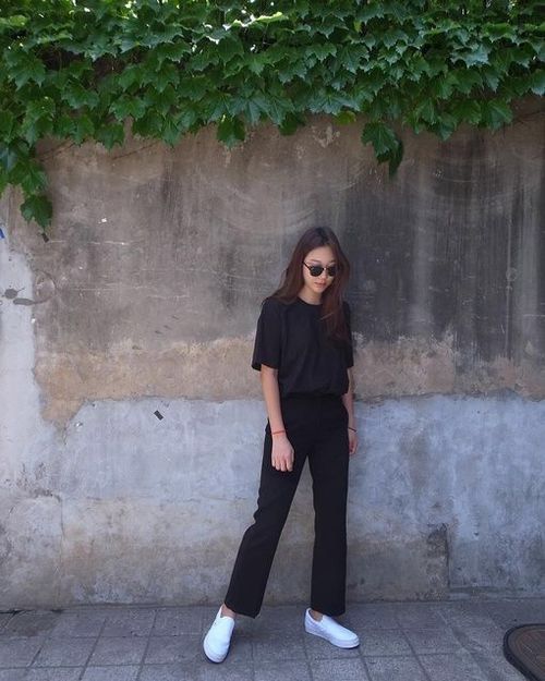 asian woman wearing t shirt and black trousers