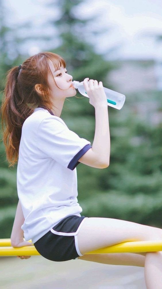 Girl drinking water after exercising