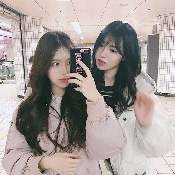 Girl wearing similar clothes taking selfie