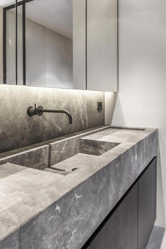 minimalist bathroom with integrated sink and black wall mounted tap faucet