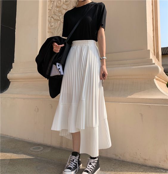 asian woman wearing black t shirt and white midi skirt