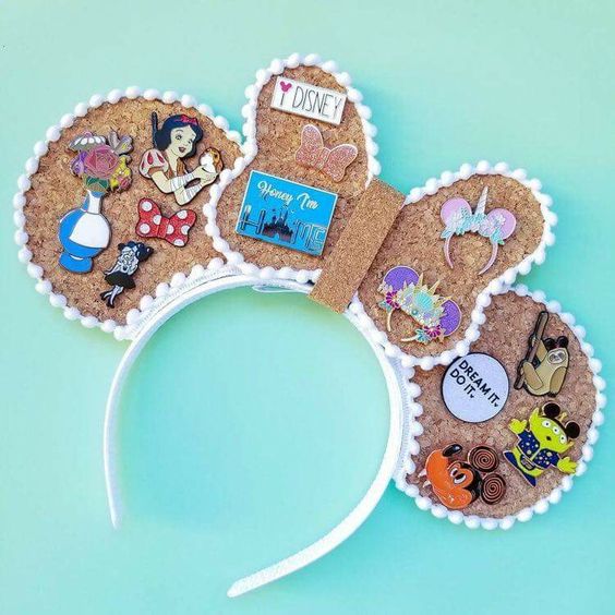 disney pins on a Minnie Mouse ear headband pin board