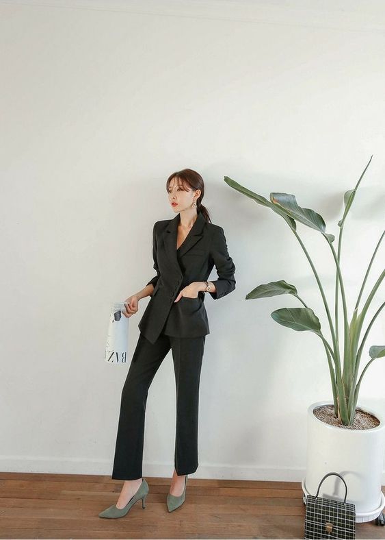 asian woman wearing black blazer and trousers