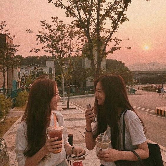 Two girls laughing on the streets