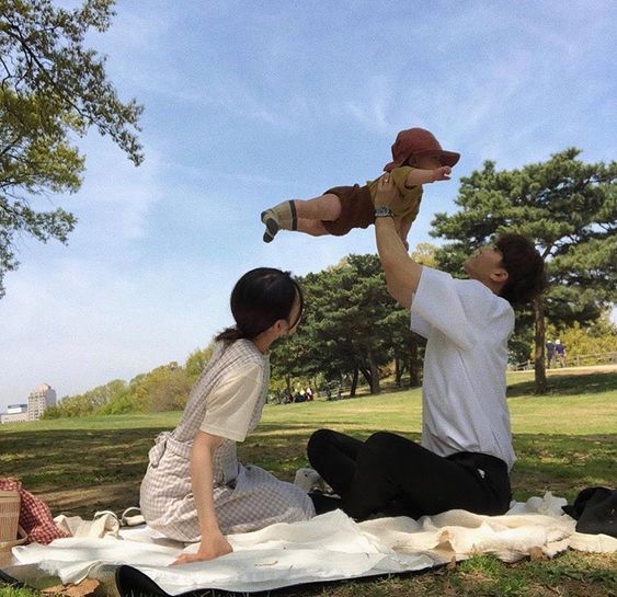 Asian couple and child having a picnic