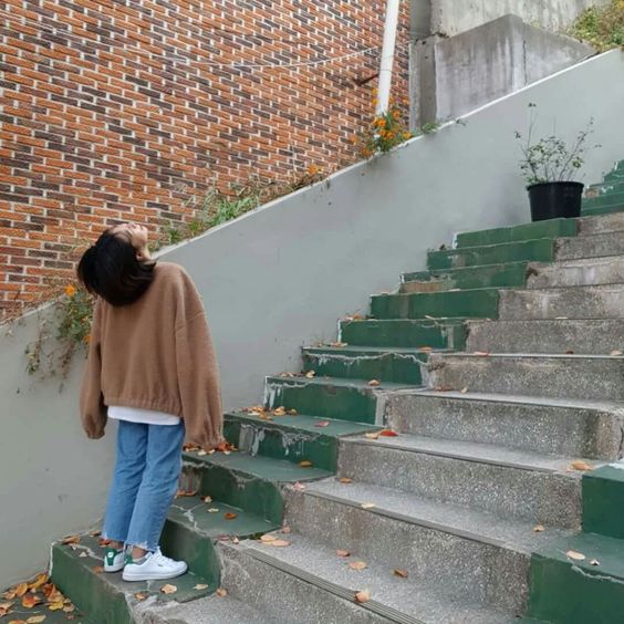 asian girl standing on stairs and looking up