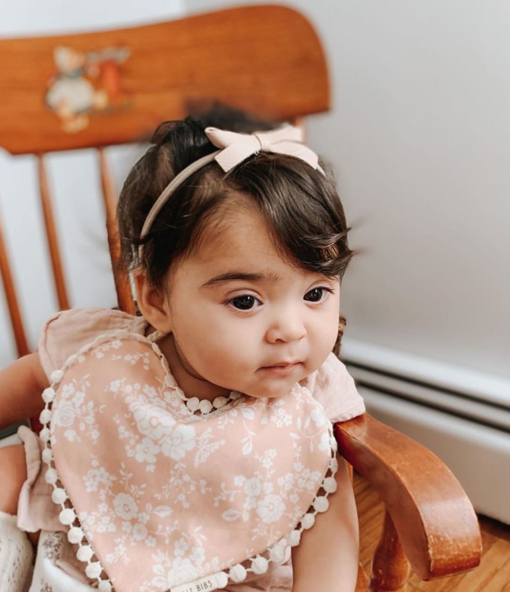 baby girl wearing Billy Bibs heart-shaped floral bib