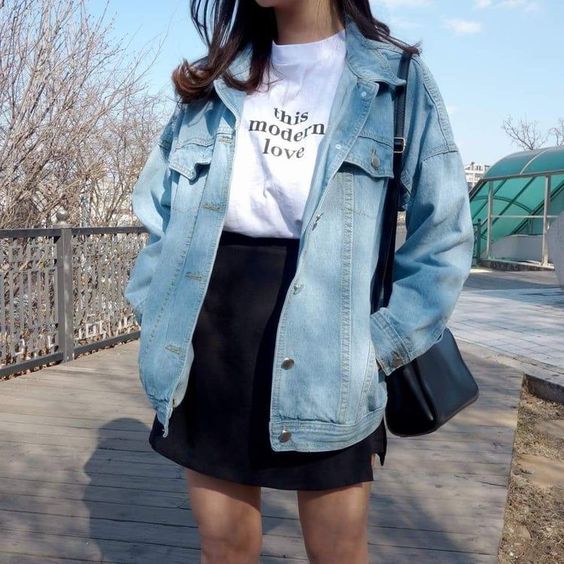 asian woman wearing demin jacket and black mini skirt