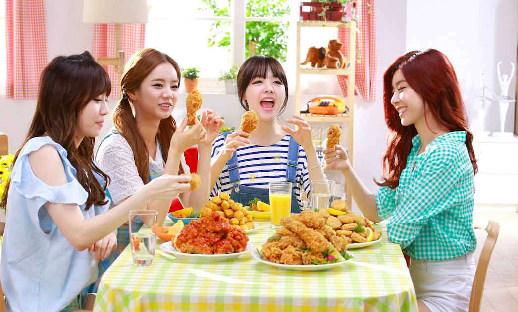 Girls eating chicken