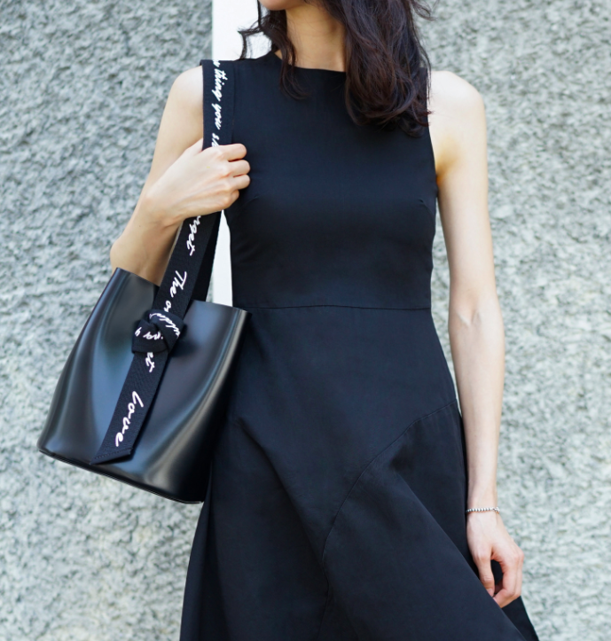 KWANI black bucket bag carried on shoulder
