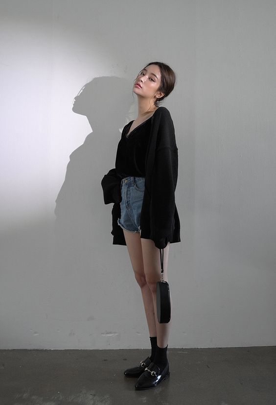 asian woman wearing black cardigan and demin shorts