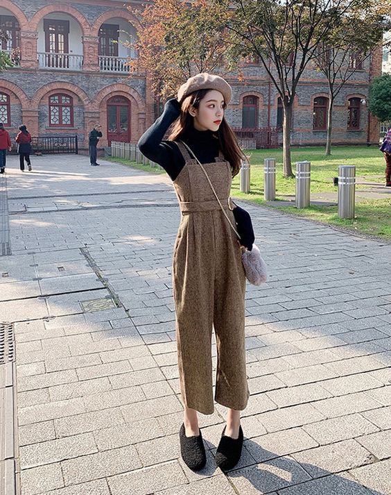 asian woman wearing black turtleneck top and jumpsuit