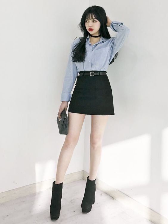asian woman wearing black skirt and blue shirt