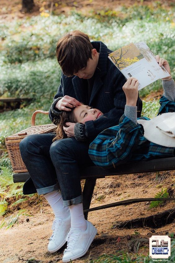 asian couple with girl lying on boy's lap