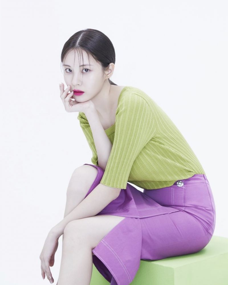 Seohyun wearing green top and purple skirt