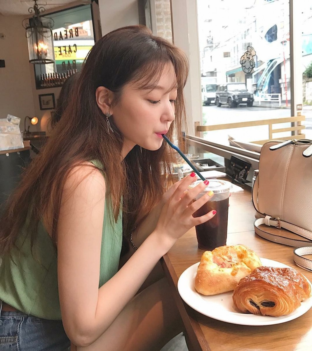 Girl at cafe drinking coffee