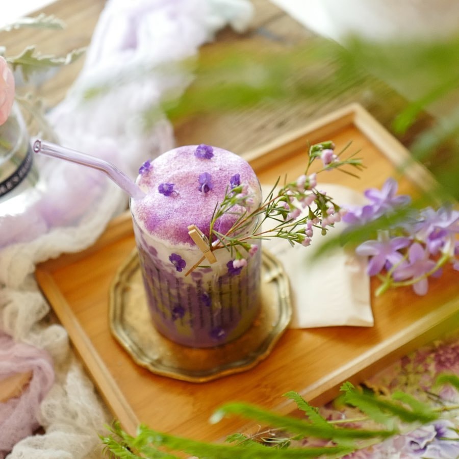 purple floral drink on tray at Cafe De Nicole's Flower