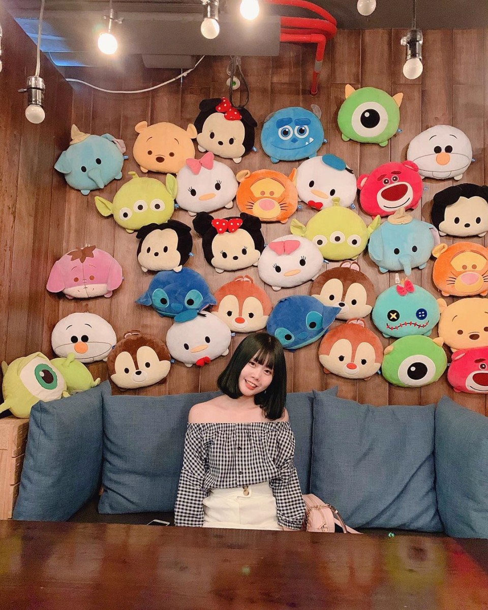 girl in front of Disney Tsum Tsum background at TankQ Cafe & Bar