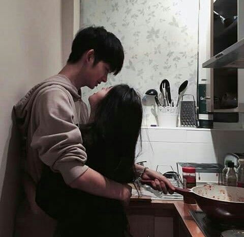 asian couple cooking together