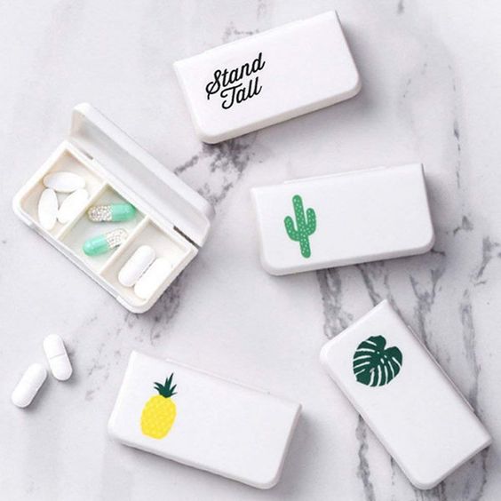 white pill boxes with illustrations