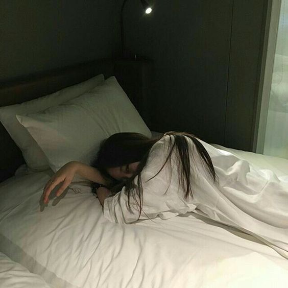 asian girl wearing white lying in bed