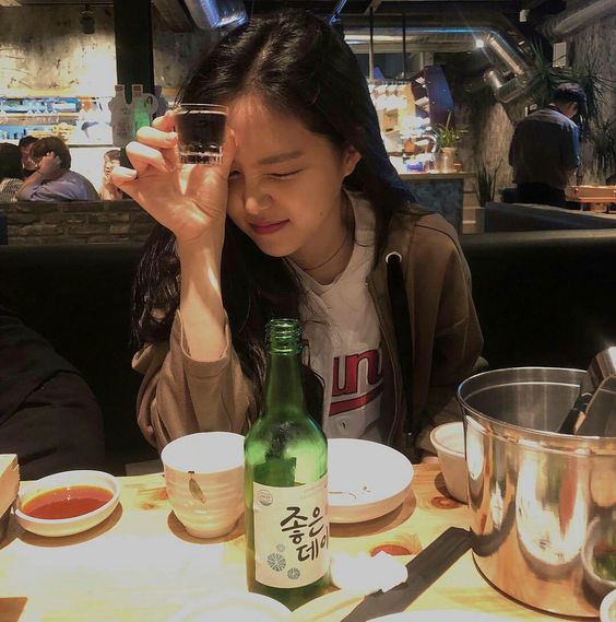 girl drinking soju in restaurant