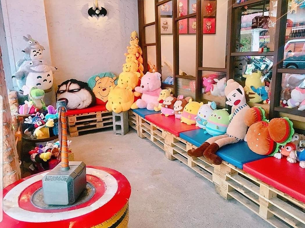 TankQ Cafe & Bar outdoor seating area with Disney plush toys