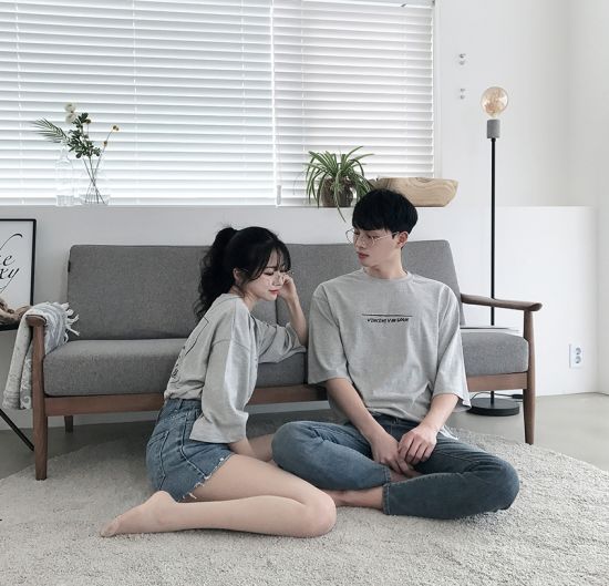 asian couple wearing matching grey t shirts and jeans