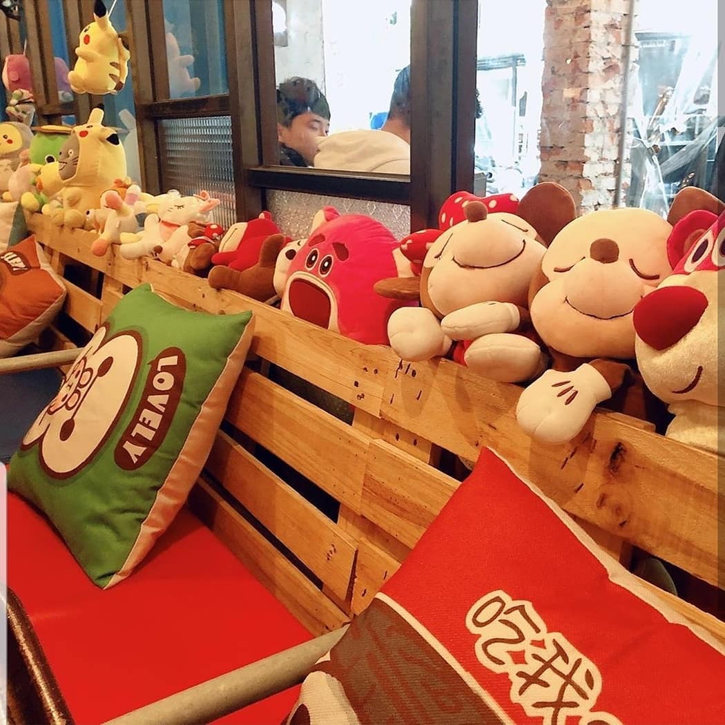 TankQ Cafe & Bar seating area with Disney plush toys