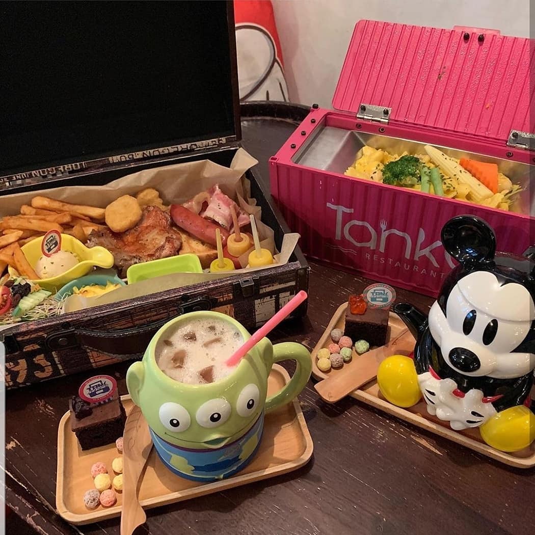 TankQ Cafe & Bar food in trunk suitcases with alien and Mickey Mouse mugs