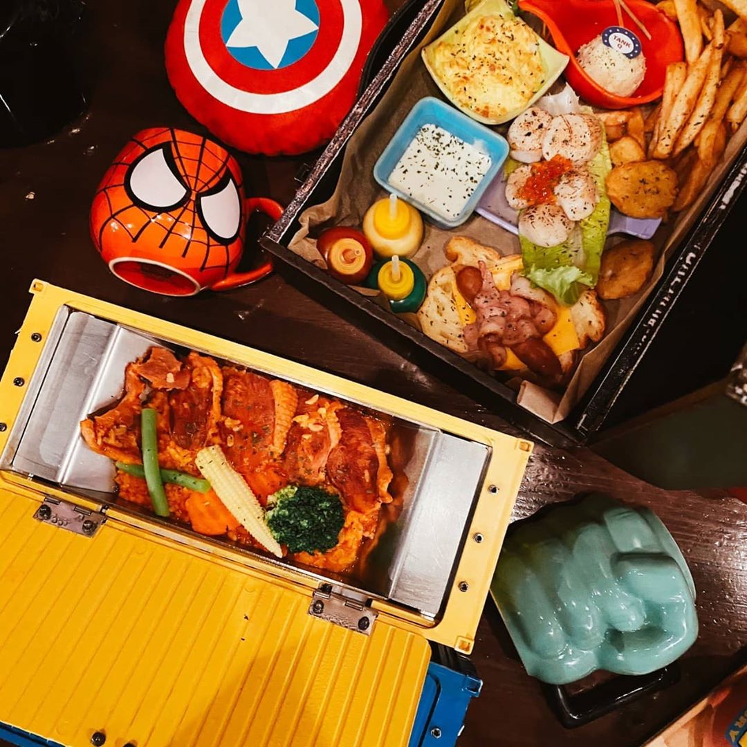 TankQ Cafe & Bar food in trunk suitcases with Spiderman and capital America mugs