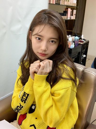 asian girl with long brown hair wearing yellow hoodie
