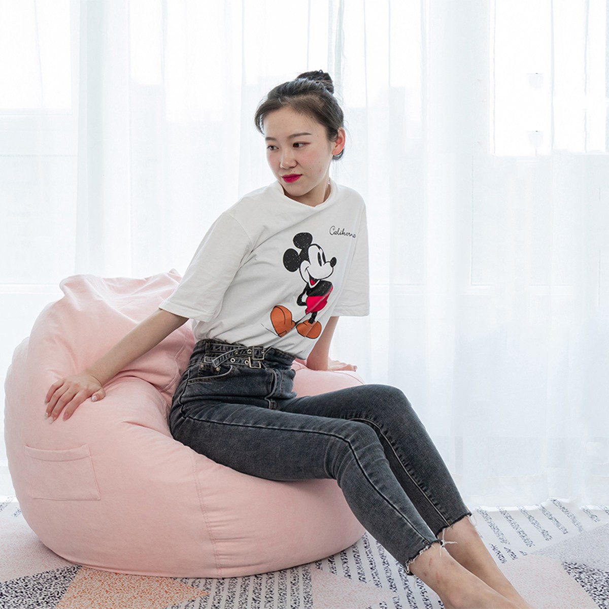 girl sitting on Pink bean bag