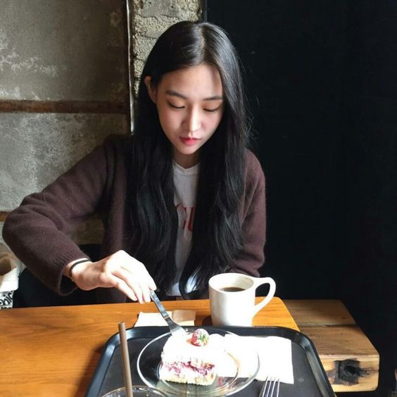 asian girl eating cake and drinking coffee