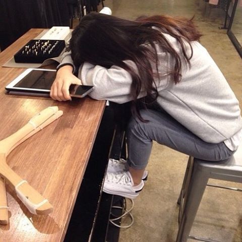 asian girl sitting down sleeping on table