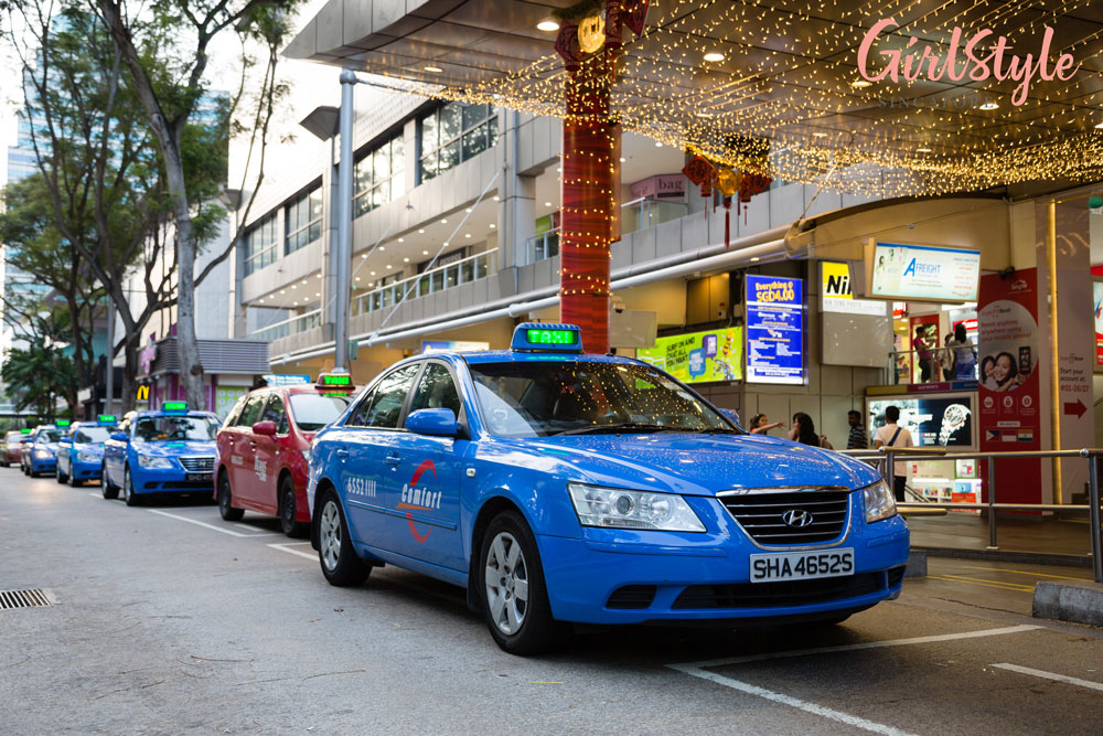 taxis lined up in front of a shopping mall in singapore
