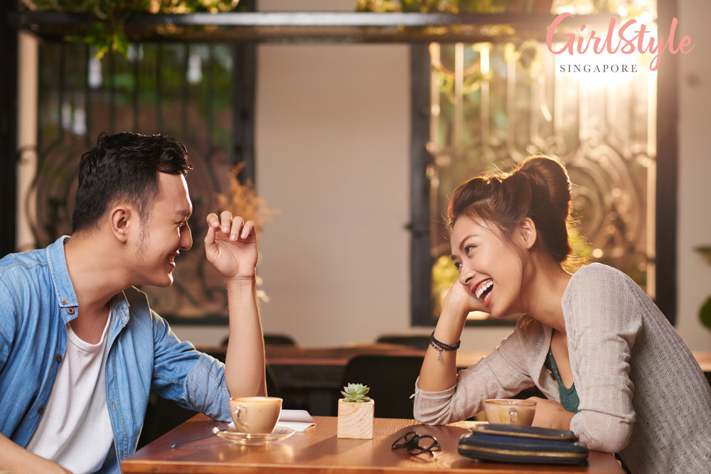 asian couple chatting over drinks in a cafe