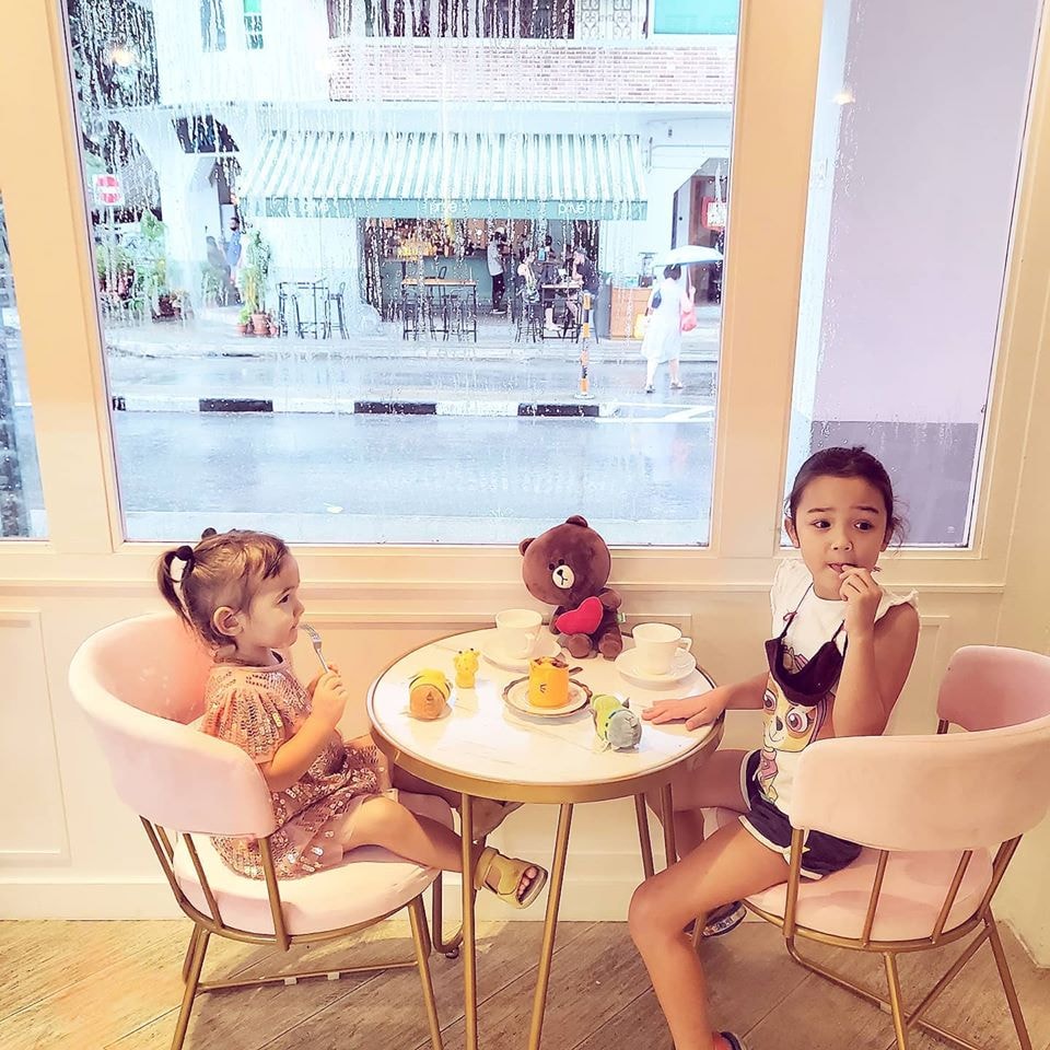 kids sitting on pink velvet chairs in Little House of Dreams
