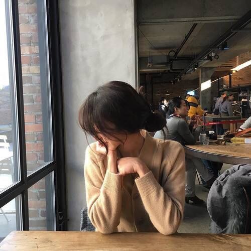 Girl sitting alone in a cafe