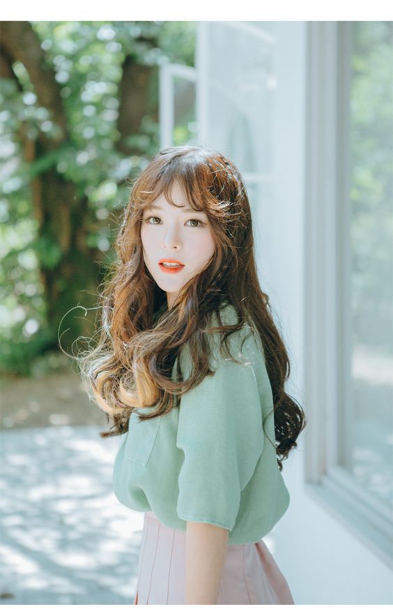 asian girl with long dark brown hair and curtain bangs wearing mint green blouse