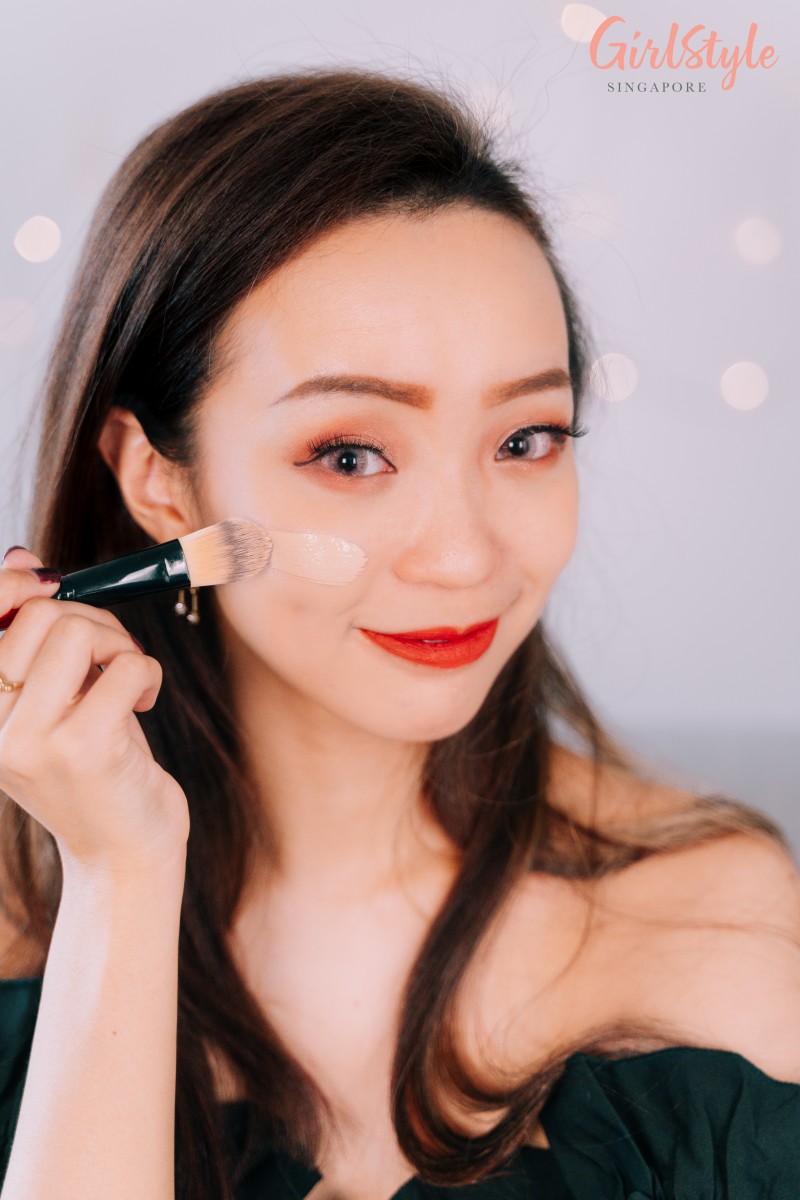 Model applying The Face Shop foundation