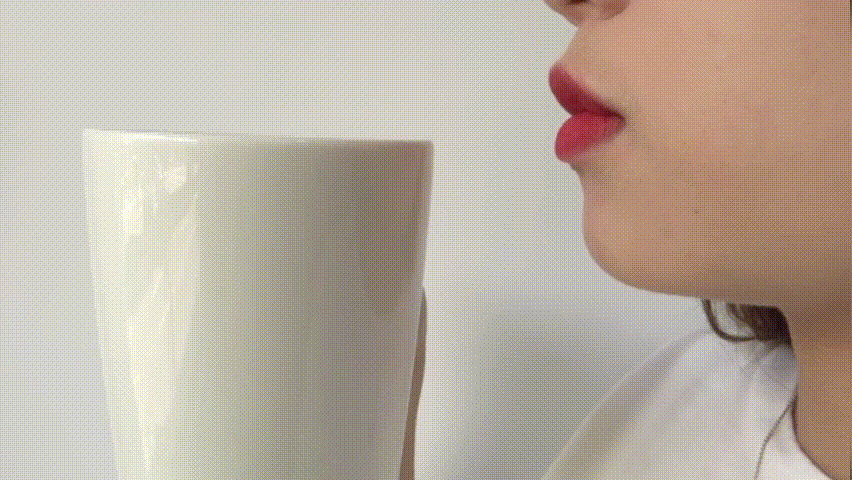 drinking from cup while wearing Q'her X Sumikko Gurashi Herbs Long Lasting Lip Stain 