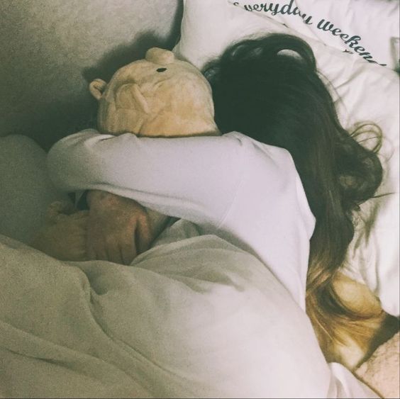 Sleeping while hugging teddy bear