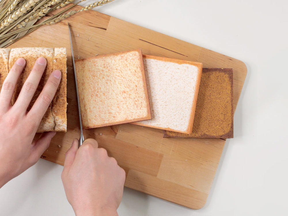 Daycraft realistic-looking toasted bread notebooks on wooden chopping board