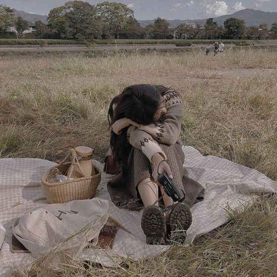 Girl on a picnic with film camera in hand