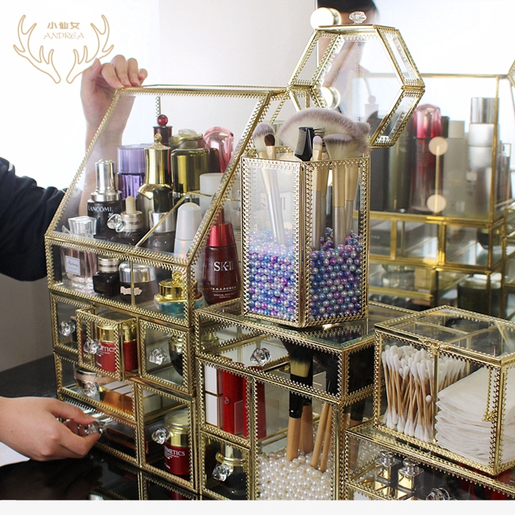 Glass storage box with gold detail to store makeup