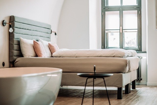 minimalist bedroom with side table and bathtub