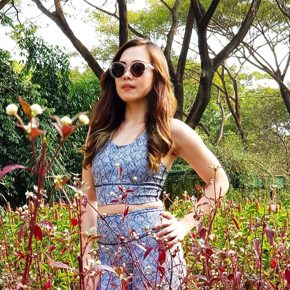 Model in fitness wear with transparent frame sunglasses